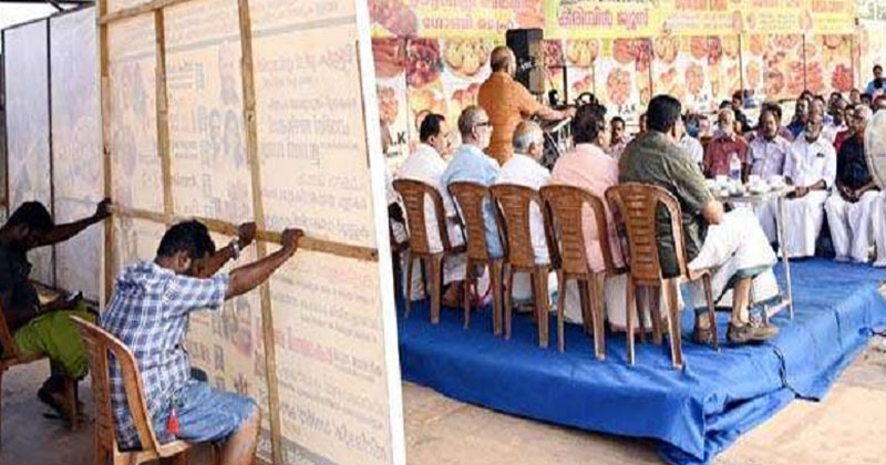 മന്ത്രിയുടെ പ്രസംഗത്തിന് വേദിയൊരുക്കാന്‍ തൊഴിലാളികള്‍ക്ക് എട്ടിന്‍റെ പണി നല്‍കി സംഘാടകർ; മണിക്കൂറുകളോളം വലിയ ബോർഡും താങ്ങിപ്പിടിച്ച് തൊഴിലാളികൾ